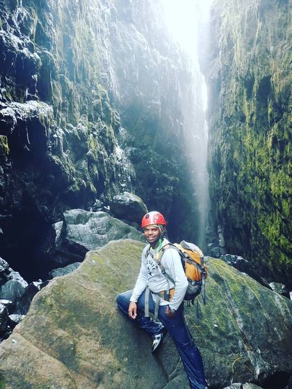 Fully equipped and confident. This graduate is standing in a canyon, wearing the gear and the skills he earned through our courses.