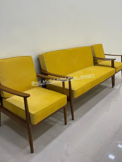 A vibrant mid-century modern sofa set, featuring a three-seater and two matching armchairs. I crafted this set from solid teak with a warm walnut finish and upholstered it in a bold yellow fabric, showing how customization can bring a pop of color and personality to your living room.