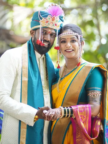 A tender moment, with the couple holding hands. The bride's makeup is soft and romantic, perfect for capturing the love between them.