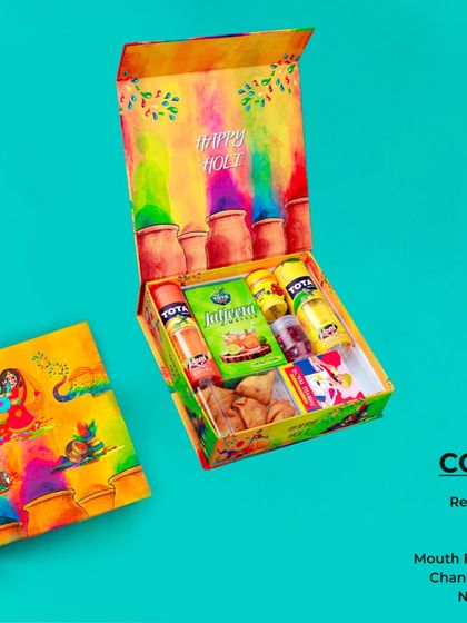A complete Holi treat box. This hamper includes real gulal, thandai, jaljeera, mouth freshener, namkeen, and chandan tika. It’s a mix of colors, flavors, and tradition.