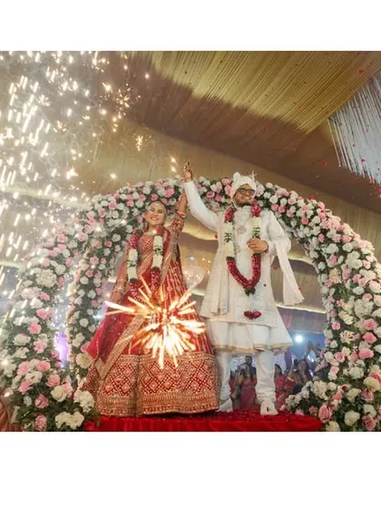 A collage of key ceremony moments. From the sindoor application to the celebratory varmala with sparklers, these images tell the story of a wedding ceremony filled with tradition and joy.