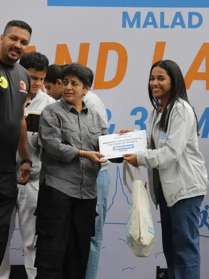 Presenting an award to a participant at the Decathlon Malad launch event. We believe in celebrating every effort and milestone in the fitness journey.
