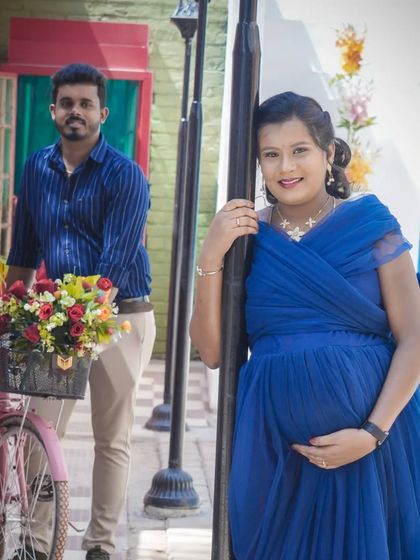 A creative shot using a pink bicycle prop at one of my themed sets. Props like this can add a touch of whimsy and personality to your maternity photos.