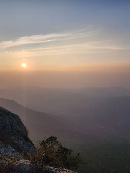 The sun sets over the hazy, layered hills of the Eastern Ghats. This is the kind of breathtaking view you can expect from the eco-lodge where we stay during the Yercaud tour.