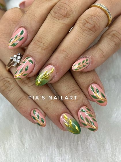 Green leaf patterns with a touch of gold chrome, hand-painted for a fresh, botanical look.