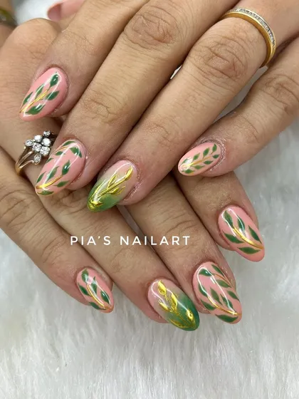 Green leaf patterns with a touch of gold chrome, hand-painted for a fresh, botanical look.