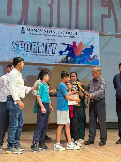 This is Vivansh Gupta receiving his second-place prize in the U-11 boys' category at the Manav Sthali School tournament. His hard work in training really showed during his matches.