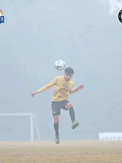 A player chests the ball down, showing great control and preparing for the next phase of play.