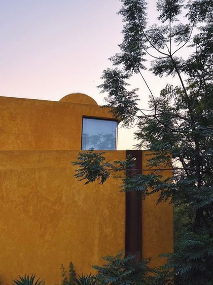 A window reflects the dusk sky, blurring the boundary between the interior and the world outside.