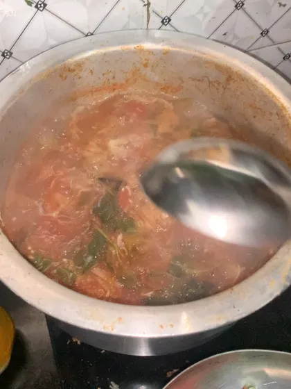 A simple fish curry simmering on the stove.