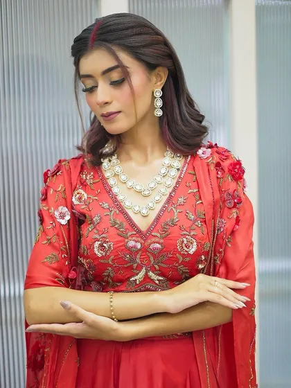 A close-up shot focusing on the client's soft, festive makeup and the delicate pearl necklace that completes her look.