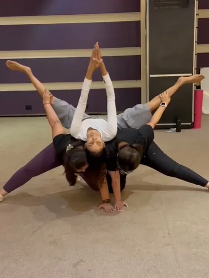 A beautiful ACRO split created by a group of dedicated students. This pose is a testament to teamwork, flexibility, and collective strength.