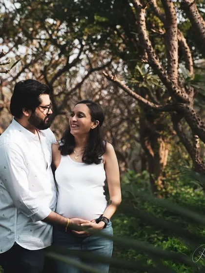 A walk through a wooded area provides a serene and natural backdrop for a maternity session. I love capturing these gentle moments where a simple glance between a couple says everything about their love and excitement.