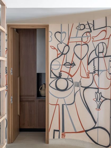 A detail of the abstract figures and hearts in the line-art mural.