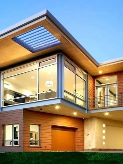 We design homes with dramatic architectural elements, such as this large cantilevered volume with floor-to-ceiling windows. This feature not only creates a stunning visual but also floods the interior living space with natural light.