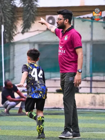 A coach guides a young player, demonstrating our commitment to mentorship and individual development.