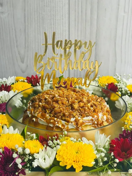 A birthday celebration featuring my Butterscotch Caramel Tres Leches. This cake is soaked in rich butterscotch milk and topped with crunchy almond praline and a personalized name topper.