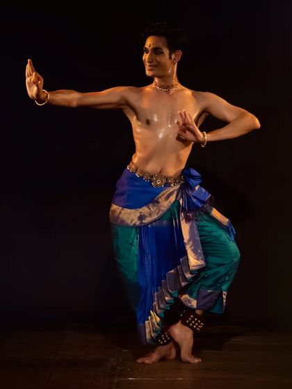A strong, defined stance from a live performance. This demonstrates the precise body control and posture that forms the foundation of the Kuchipudi technique.