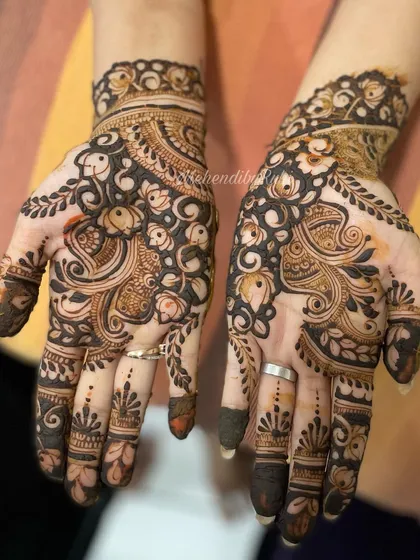 From Karwa Chauth 2022, this design features beautiful paisley and bird motifs. The patterns are dense and flowing, creating a very traditional and festive feel.