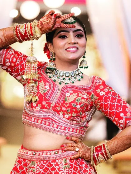 A fun and stylish pose from a bride in her vibrant red lehenga. We work with you to capture portraits that are both beautiful and full of personality.