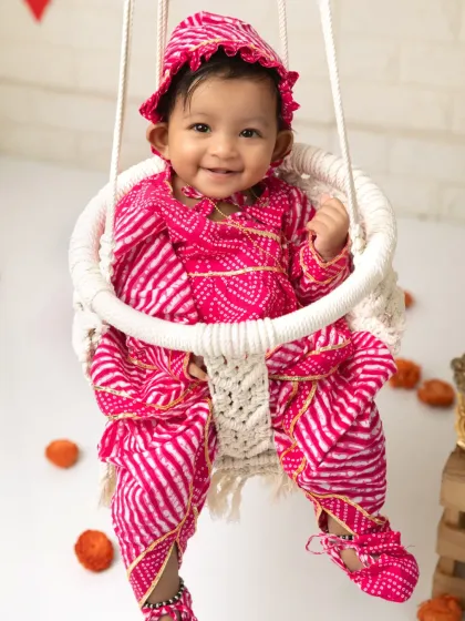 Celebrating the local culture with a Raja Parba mini session. This little one looks adorable in a traditional pink bandhani outfit on a decorated swing.