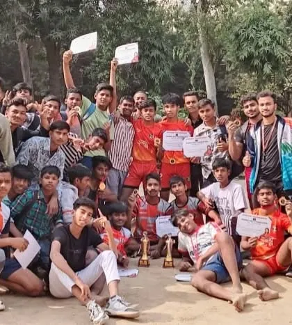The entire team celebrating their first-place victory. You can see the happiness and pride on their faces, holding up their certificates and trophies.
