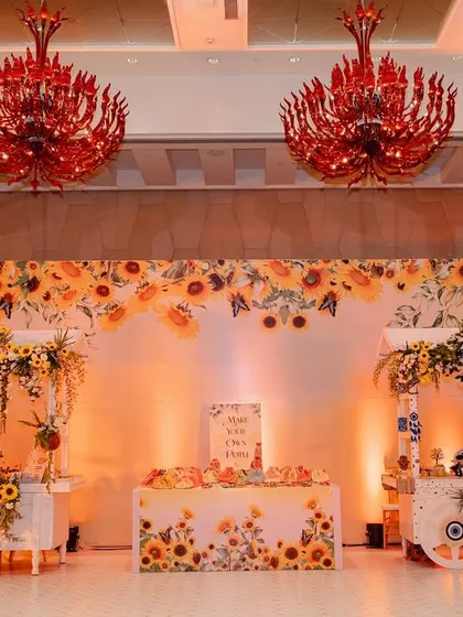 A charming decor setup at the Haldi, featuring sunflower-themed carts and backdrops. These little corners provide perfect photo opportunities for guests.