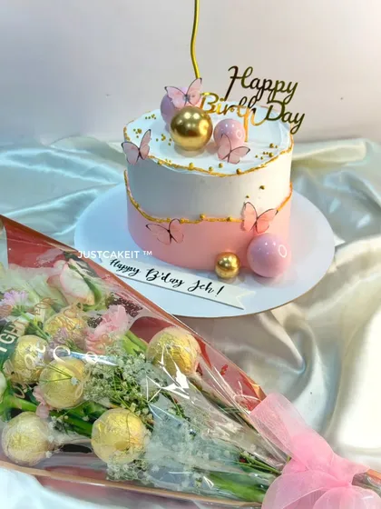 This elegant birthday surprise features a pastel pink and white cake with delicate edible butterflies. It was delivered at midnight along with a beautiful matching chocolate and flower bouquet.