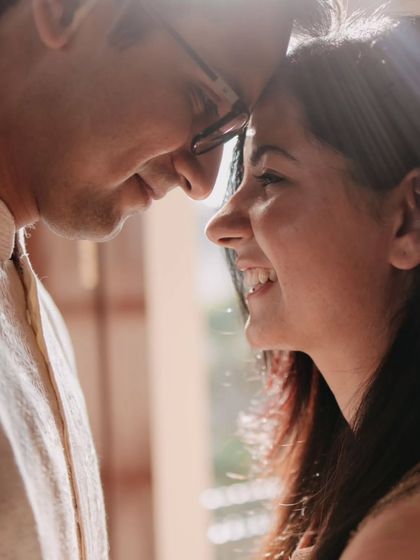 A close-up shot capturing the pure, uninhibited joy in the bride's smile. These are the quiet, whispered moments of love that we strive to freeze in time.