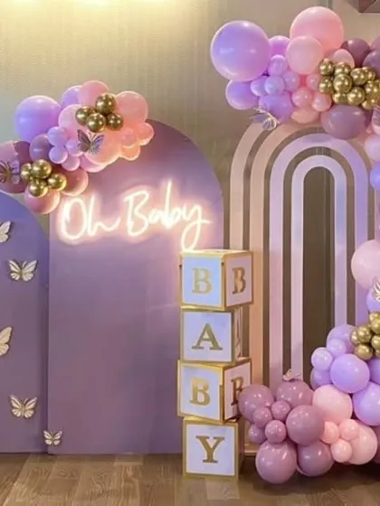 Another angle of the purple butterfly baby shower, showing the full arrangement and the "Oh Baby" neon sign.