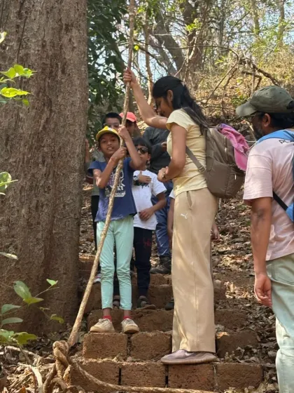 Using a rope to navigate a steeper section of the trail. We ensure our forest trails have elements of fun and challenge, suitable for young adventurers.