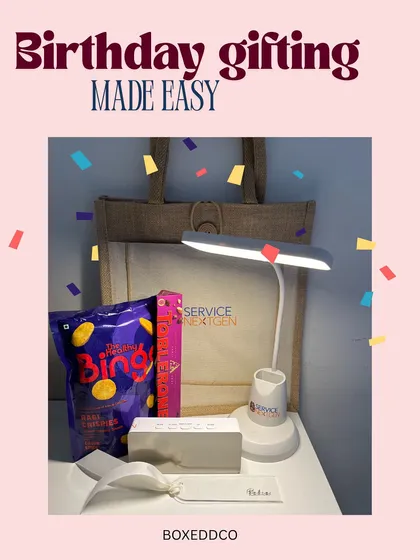 Corporate birthday gifting made easy and fun. This hamper includes a desk lamp with a pen stand, snacks, and other useful items packed in a reusable jute tote bag.