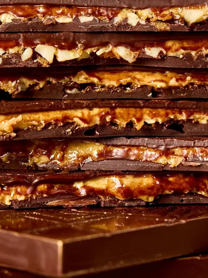 A stack of our Bombay Kaju Krunchy Bars, showing the delicious layers of chocolate, praline, and sev.