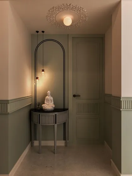 This hallway nook features a serene Buddha statue on a modern console table, framed by a painted arch. It’s a perfect example of creating a peaceful moment in an unexpected place.