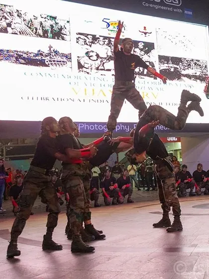 A dynamic shot of an Indian Army team forming a human pyramid during their performance at Cyberhub. For large public events, I focus on capturing impressive, coordinated action that showcases the scale of the celebration.