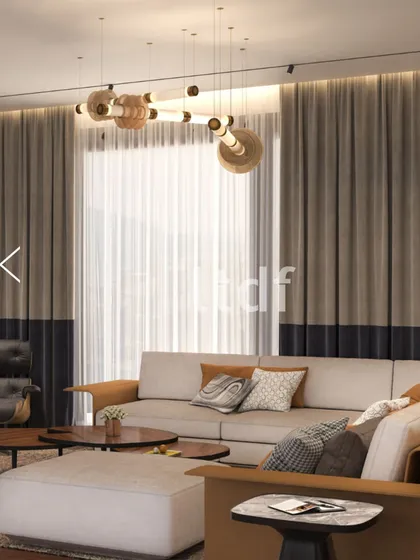 In this refined living space, form and function blend effortlessly. We used clean lines, a warm neutral palette, and thoughtfully layered textures to create an inviting atmosphere, anchored by a sculptural chandelier that adds a touch of modern artistry.