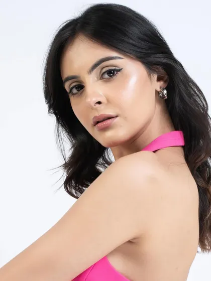 This angle highlights the winged eyeliner and the glowing highlighter on the cheekbones.