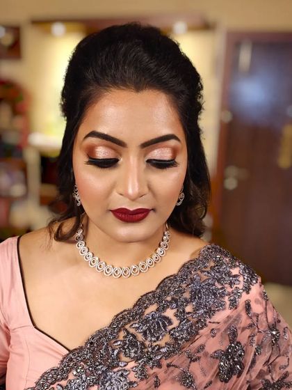 A close-up of the eye makeup, which features a soft brown and gold blend.