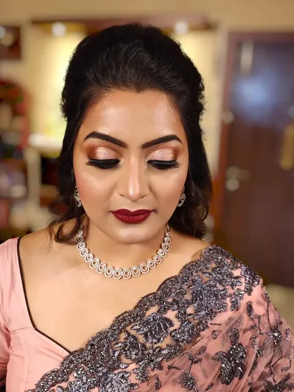 A close-up of the eye makeup, which features a soft brown and gold blend.