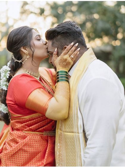 A sweet, tender kiss on the forehead. This portrait of Gayatri and Akash is full of warmth and affection, a beautiful, unscripted moment from their wedding day.