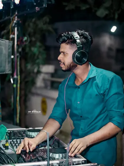 Another angle from a live gig, showing me at the DJ console. I am always aware of the crowd's reaction, ready to switch up the vibe at a moment's notice.