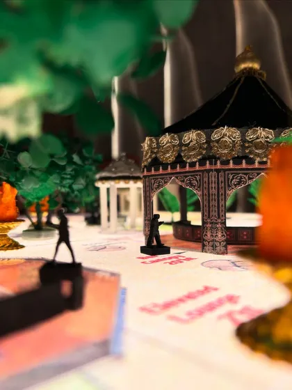 The miniature model showcases the placement of canopies and even tiny human figures to give a sense of scale. This helps my clients and me understand how the space will feel when it's full of guests.