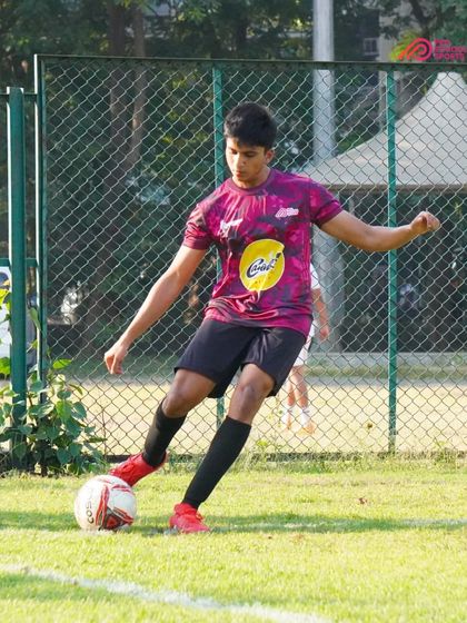 Close control and focus as a player moves the ball down the line.