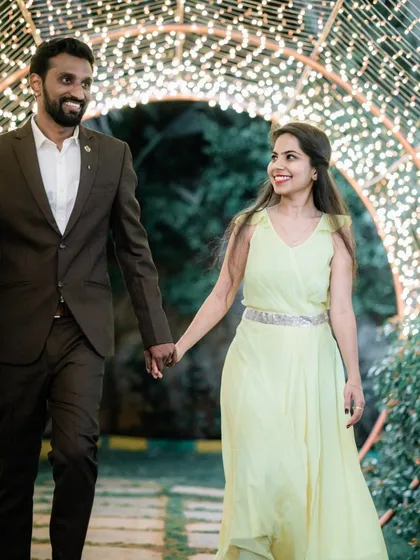 A happy couple walking together, showcasing their stylish outfits and joyful connection.