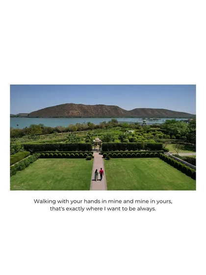 A stunning wide shot using a drone to capture the couple walking through the immaculate gardens of Raffles Udaipur. The scale of the landscape emphasizes the grandness of their journey together.