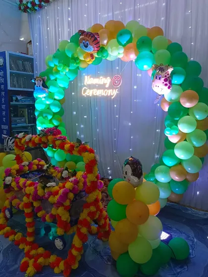 The jungle-themed naming ceremony setup with green lighting.