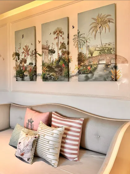 Another view of the three-piece wall art, showcasing how the panels tell a continuous story of a lush, imaginative landscape. They serve as a beautiful backdrop for the custom-styled cushions.