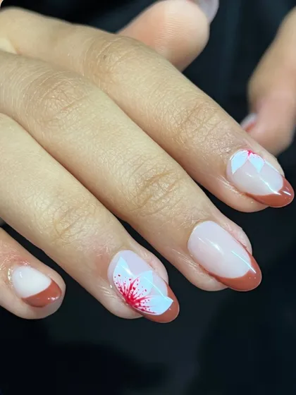 A French manicure kissed by spring flowers. The contrast between the deep red tip and the soft white petals creates a really beautiful and eye-catching design.