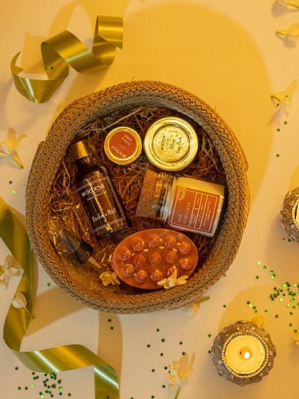 This festive hamper, arranged in a beautiful jute basket, is perfect for Diwali. It contains a selection of my bestsellers, including a scented candle, massage soap bar, and other skincare goodies, surrounded by decorative diyas.