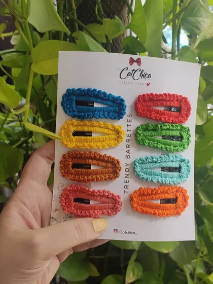 Holding up the set of eight trendy barrettes against a natural background. The colors really pop!